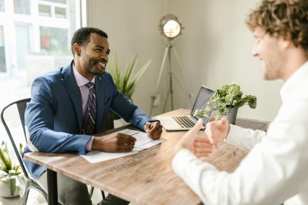 Men Sitting at Table Smiling